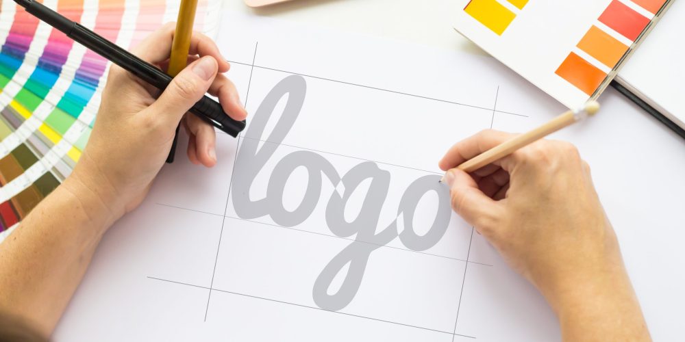 Hands drawing a logotop view